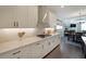 Well-appointed kitchen with white cabinets, quartz countertops, stainless steel appliances, and access to the dining area at 518 Newstead Way, Woodstock, GA 30188