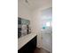 Convenient laundry room features a countertop and cabinet providing space for folding and storage at 518 Newstead Way, Woodstock, GA 30188