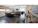 Inviting living room features hardwood floors, a fireplace, large windows, and an open layout with a dining area at 518 Newstead Way, Woodstock, GA 30188
