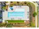 Aerial view of a community pool with lounge chairs and manicured landscaping at 518 Newstead Way, Woodstock, GA 30188