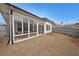 Light-filled screened porch with wood furniture provides a great place for relaxation and entertaining at 518 Newstead Way, Woodstock, GA 30188