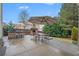 Backyard patio with outdoor kitchen, fireplace, umbrella-covered dining table and seating at 606 Discovery Ct, Acworth, GA 30102