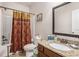 Bathroom with granite countertop vanity, framed mirror and decorative shower curtain at 606 Discovery Ct, Acworth, GA 30102