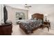 Comfortable bedroom featuring a ceiling fan, a window with blinds, and stylish dark bedding at 606 Discovery Ct, Acworth, GA 30102
