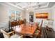 Elegant dining room with coffered ceiling, chandelier, and ample natural light at 606 Discovery Ct, Acworth, GA 30102