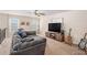 Cozy living room with a large sectional sofa, entertainment center, and natural light at 606 Discovery Ct, Acworth, GA 30102