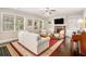 Comfortable living room with fireplace, built-in shelving, and lots of natural light at 606 Discovery Ct, Acworth, GA 30102