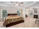 Spacious main bedroom featuring a tray ceiling, fireplace, and ample natural light from large windows at 606 Discovery Ct, Acworth, GA 30102