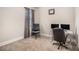 A well-lit office space features neutral walls and plush carpeting, ideal for a home office or study area at 606 Discovery Ct, Acworth, GA 30102