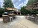 Outdoor patio with bar, fireplace, dining table, and seating for entertaining guests at 606 Discovery Ct, Acworth, GA 30102