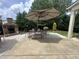 View of outdoor patio with stone fireplace, and outdoor dining under a large umbrella at 606 Discovery Ct, Acworth, GA 30102