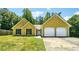 Charming home featuring a two-car garage and a well-maintained front yard at 6445 Marsham Dr, Atlanta, GA 30349