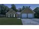 Charming single-story home featuring a two-car garage and well-maintained lawn at 6445 Marsham Dr, Atlanta, GA 30349