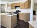 Spacious kitchen featuring tan countertops, a gas range, and dark wood flooring at 6445 Marsham Dr, Atlanta, GA 30349