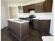 Kitchen with a center island featuring white countertops, dark cabinets, and stainless steel appliances at 6445 Marsham Dr, Atlanta, GA 30349