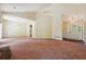 Spacious living room with vaulted ceilings, lots of light and neutral-toned carpet at 6445 Marsham Dr, Atlanta, GA 30349
