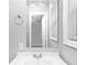 Close up of bathroom mirror, sink, and towel rack, with a window to provide natural light at 6884 Stephens Dr, Rex, GA 30273