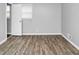 The bedroom features neutral wall color, hardwood floors, and a door, bathed in soft natural light at 6884 Stephens Dr, Rex, GA 30273