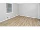 Neutral bedroom featuring wood-look vinyl floors and a window with blinds at 6884 Stephens Dr, Rex, GA 30273