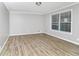 Bright and airy bedroom featuring a window and modern wood-look vinyl flooring at 6884 Stephens Dr, Rex, GA 30273