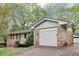 Charming home with attached garage, beautiful landscaping, and inviting curb appeal at 6884 Stephens Dr, Rex, GA 30273
