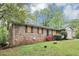 Brick home with lush greenery, offering a blend of classic charm and natural beauty at 6884 Stephens Dr, Rex, GA 30273