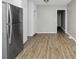 Kitchen boasts stainless steel fridge, modern cabinets, and wood-look vinyl floors at 6884 Stephens Dr, Rex, GA 30273
