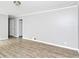 Clean living room with modern floors, light walls, and doorways leading to other spaces at 6884 Stephens Dr, Rex, GA 30273