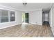 Bright living room with modern flooring, neutral walls, and a welcoming front door at 6884 Stephens Dr, Rex, GA 30273