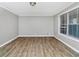 Bright living room featuring hardwood floors, a window for natural light, and neutral wall color at 6884 Stephens Dr, Rex, GA 30273