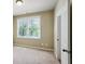 Comfortable carpeted bedroom with natural light streaming through the window, creating a serene atmosphere at 9942 Ashton Old Rd, Douglasville, GA 30135