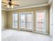 Bright, spacious bedroom with carpet, featuring double doors and large windows for natural light at 9942 Ashton Old Rd, Douglasville, GA 30135