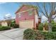 Detached two-car garage with red siding and driveway, complemented by lush green landscaping at 9942 Ashton Old Rd, Douglasville, GA 30135