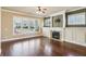 Bright living room featuring hardwood floors, a fireplace, and large windows providing ample natural light at 9942 Ashton Old Rd, Douglasville, GA 30135