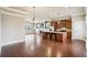 Open-concept living space with hardwood floors connecting the living room, dining area, and kitchen at 9942 Ashton Old Rd, Douglasville, GA 30135
