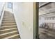 Stairway leading to the upper level, positioned near the garage entrance, offering convenient access at 9942 Ashton Old Rd, Douglasville, GA 30135