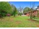 Spacious backyard with lush green grass and mature trees, perfect for outdoor activities and relaxation at 126 Washington St, Mcdonough, GA 30253