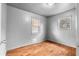 Bedroom featuring laminate wood flooring, painted walls, and two windows with blinds at 126 Washington St, Mcdonough, GA 30253