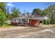 Charming single-story home with a brick foundation and covered parking at 126 Washington St, Mcdonough, GA 30253