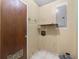Utility room with shelving, wood door, tile floors, and access to circuit breaker at 126 Washington St, Mcdonough, GA 30253