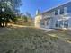 Spacious backyard with a wooden fence, mature trees, and a patio at 2013 Reserve Pkwy, Mcdonough, GA 30253