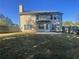 View of the home's backyard with a large lawn, a concrete patio, and a wooden fence for privacy at 2013 Reserve Pkwy, Mcdonough, GA 30253