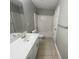 Bathroom with tile floors, single sink vanity and bathtub with shower at 2013 Reserve Pkwy, Mcdonough, GA 30253