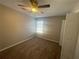 Carpeted bedroom with ceiling fan, window with blinds and a closet at 2013 Reserve Pkwy, Mcdonough, GA 30253