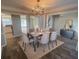 Elegant dining room with modern chandelier and dining set near the entry and stairway at 2013 Reserve Pkwy, Mcdonough, GA 30253