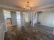 Elegant dining area featuring chandelier lighting, stylish floors, and access to the kitchen and living area at 2013 Reserve Pkwy, Mcdonough, GA 30253
