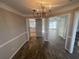 Elegant dining area featuring chandelier lighting, stylish floors, and open access to the kitchen at 2013 Reserve Pkwy, Mcdonough, GA 30253