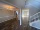 Grand entryway with wood floors, a chandelier, and a staircase leading to the upper level at 2013 Reserve Pkwy, Mcdonough, GA 30253