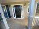 Inviting front porch featuring a black front door flanked by sidelights and sconce lighting at 2013 Reserve Pkwy, Mcdonough, GA 30253