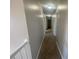 A carpeted hallway with neutral walls and recessed lighting at 2013 Reserve Pkwy, Mcdonough, GA 30253